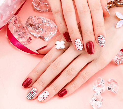 Red and white manicure created at Serene Nails
