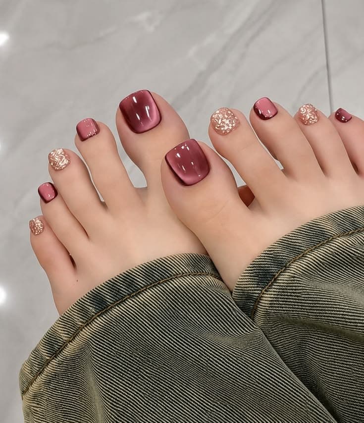 Burgundy and gold pedicure design